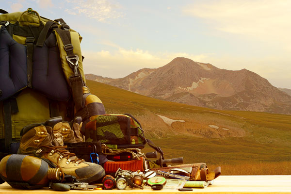 hiking gear by mountain side