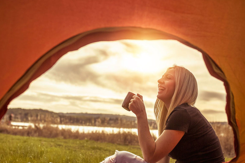 woman tent camping lake mug
